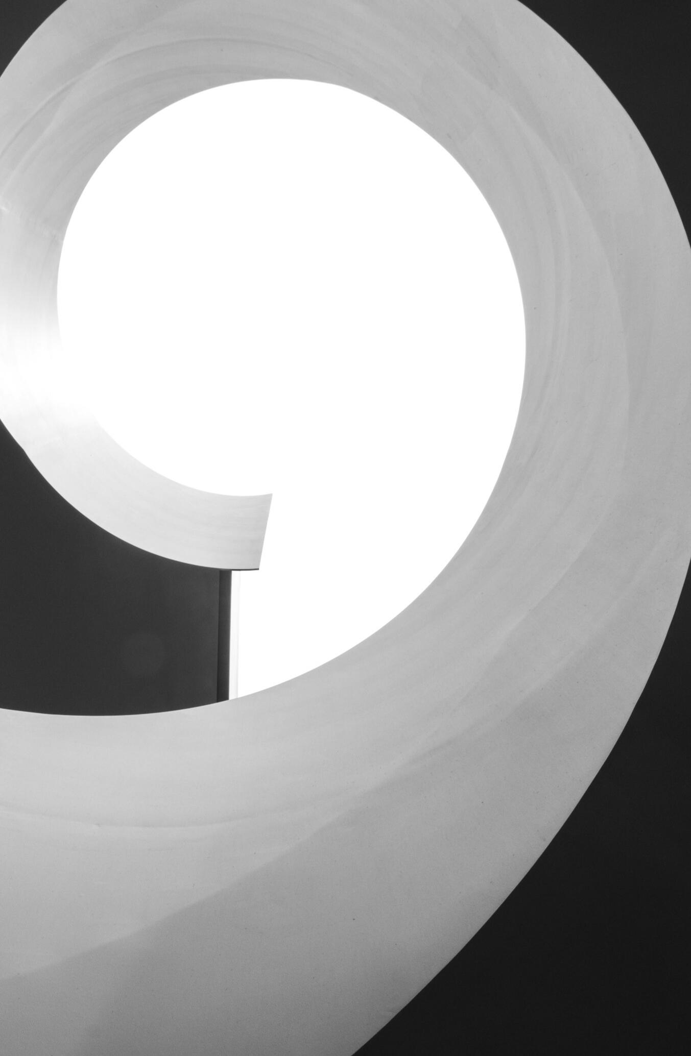 Curved architectural form opening to bright light, symbolising clarity, calm and rising toward growth